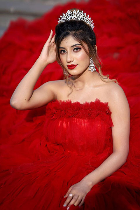 Somya Daundkar is looking like a queen in red dress and white crown.